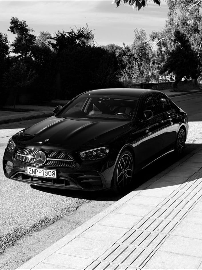 Black Mercedes-Benz E-Class sedan of the MX Transfers fleet photographed from the front